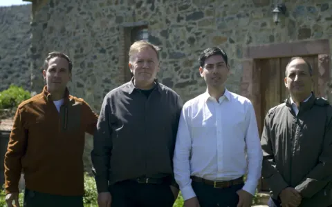 The EMFF team in front of a stone farmhouse.