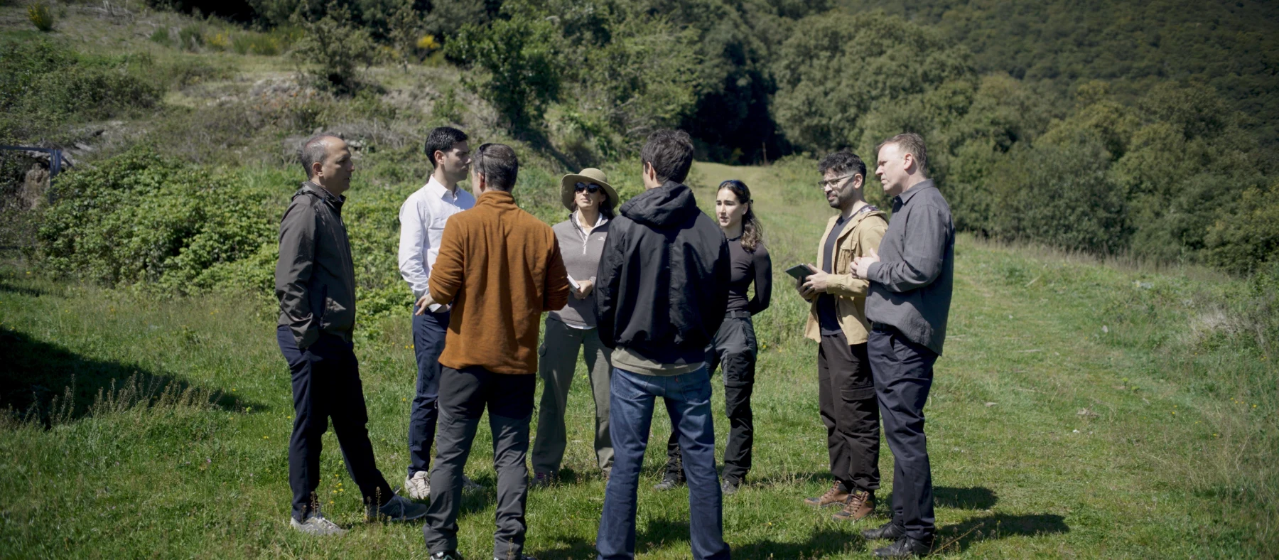 EMFF working group talking in a mountain meadow.